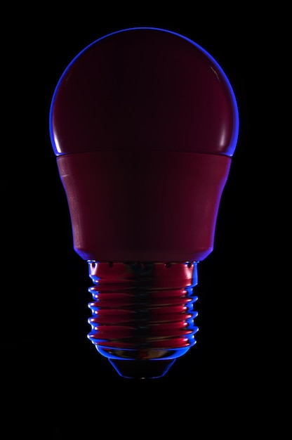 Led colored light bulb on a dark background closeup