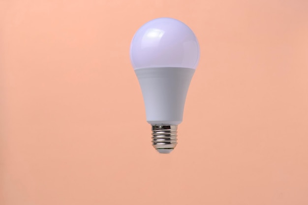 LED eco light bulb on beige background