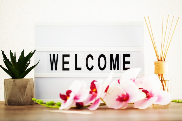 Photo led letter board with welcome word on table.