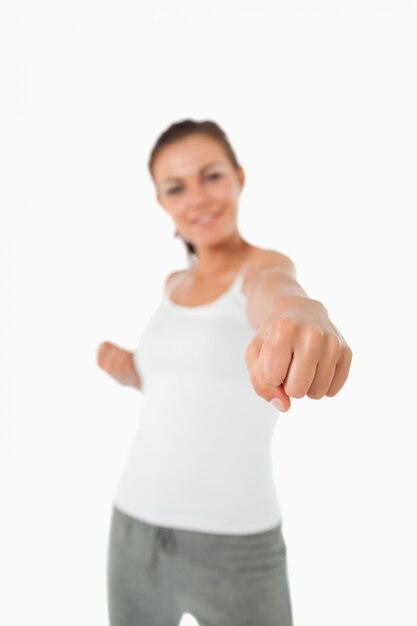 Left fist of female martial arts fighter striking