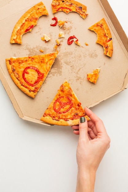 Leftover pizza food and person taking a slice