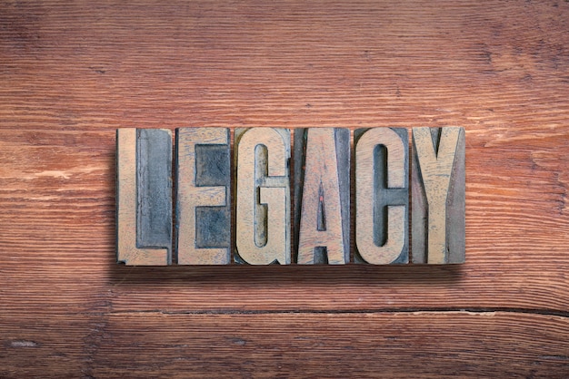 Legacy word combined on vintage varnished wooden surface