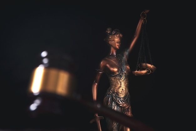 Legal justice concept goddess scales and judge's hammer on a wooden table