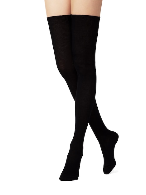 Legs in black cotton tights on white background