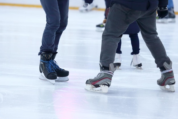 The legs of a man skating on an ice rink