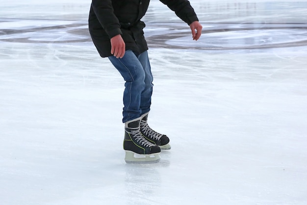 The legs of a man skating on the ice rink