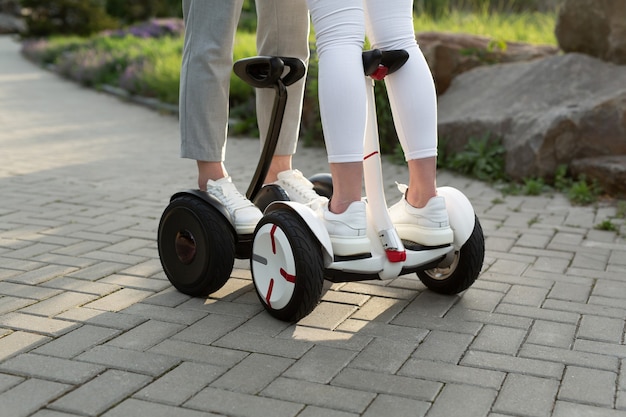 Legs of man and woman riding on the Hoverboard for relaxing