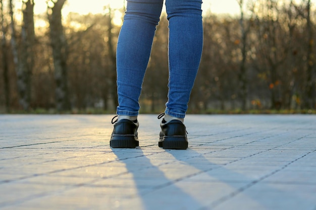 Legs of a stylish hipster girl in an outdoor park shot