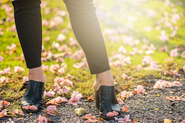 Legs view of a woman walking with flowers.Asian woman legs