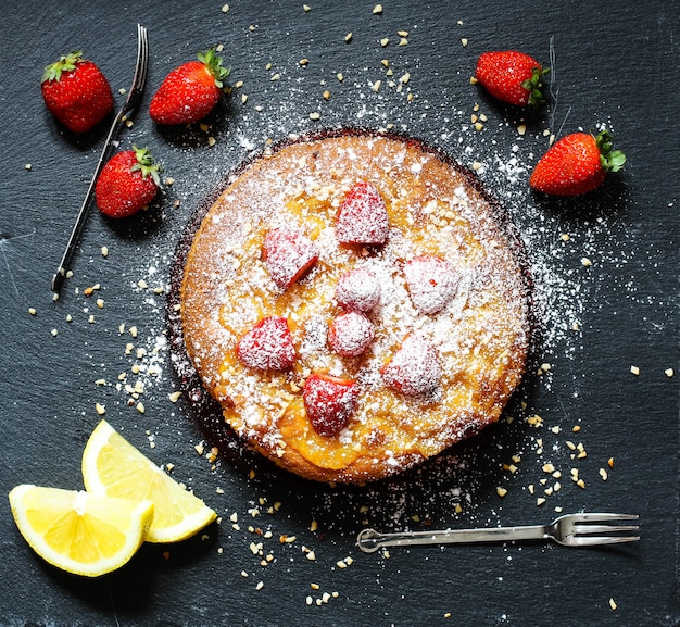 Lemon cake with strawberries, sugar end chocolate