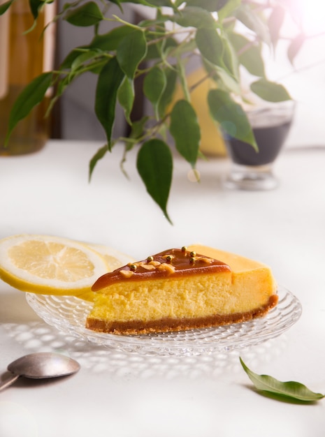 Lemon cheesecake with caramel on sunny summer background