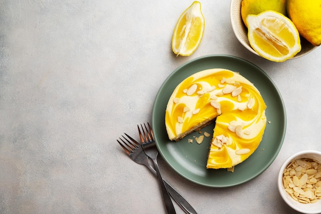 A lemon cheesecake with lemon slices on a plate.