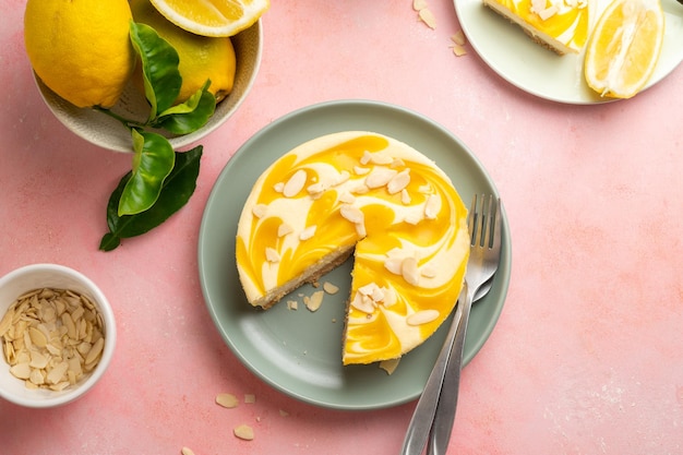 A lemon cheesecake with a slice taken out of it