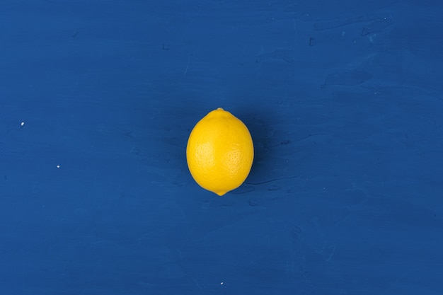 Lemon on classic blue table, top view