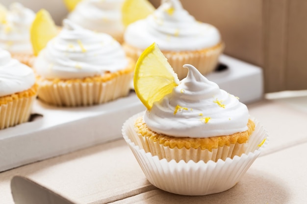 Lemon cupcakes with white cream in delivery box