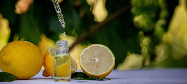 lemon essential oil and lemon fruit on a wooden white board Selective focus