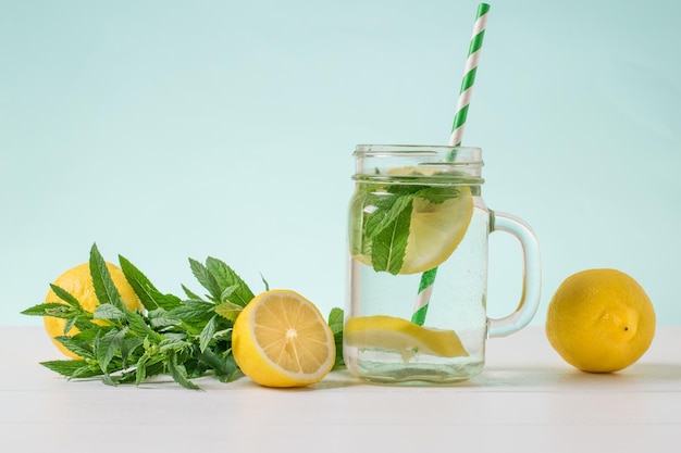 Lemon fruit a Cup of water peppermint and lemon