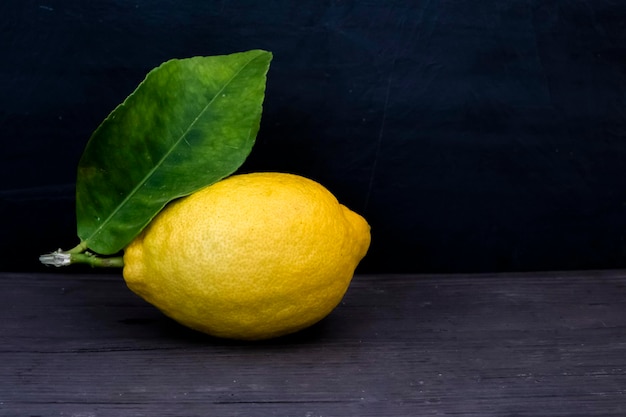 Lemon fruitLemon fruit with leaf isolated Whole lemons on a wooden table