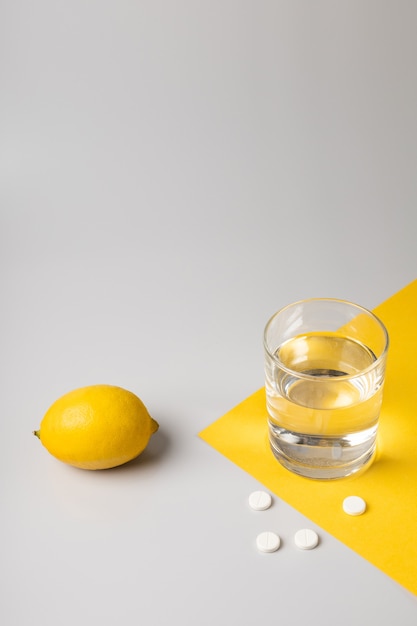 Lemon, a glass of water and medicine