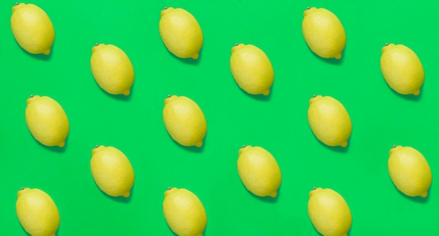 Lemon on the green background Flat lay Pattern Top view