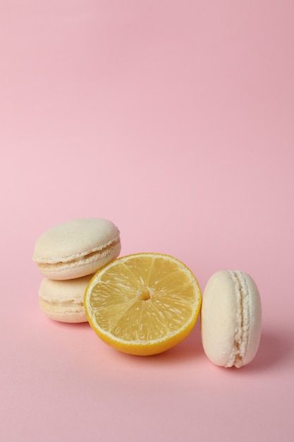 Lemon macaroons and lemon on pink background