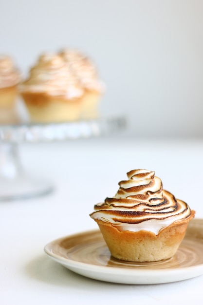 Lemon meringue tart on bright background