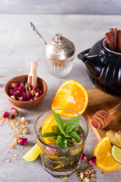 Lemon mint iced tea cocktail refreshing drink beverage in a glass on a stone table for summer days