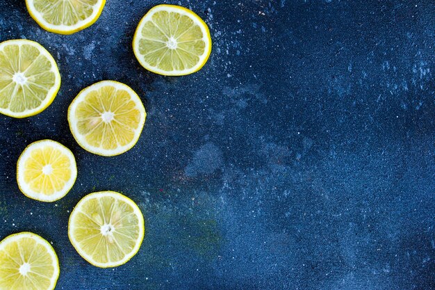 Lemon rings on the blue table, chopped lemon