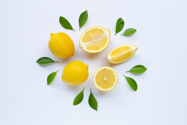 Lemon and slices with leaves isolated on white.