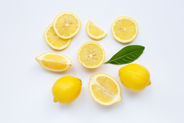 Lemon and slices with leaves isolated on white.