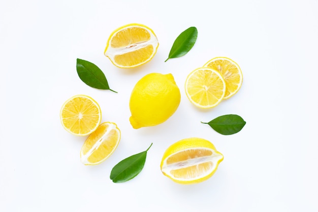 Lemon and slices with leaves isolated on white.