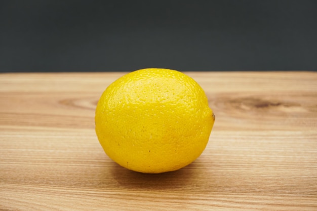 Lemon on a wooden table. Lemon close-up. Lemon. On a wooden board.