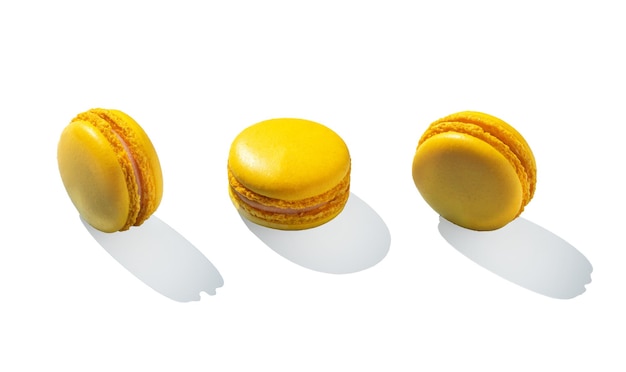 Lemon yellow macarons on invisible background isolated with hard shadows