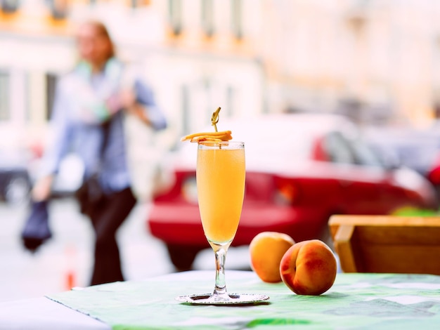 Lemonade and Bellini cocktail standing on the table at bar's terrace outdoor in the downtown