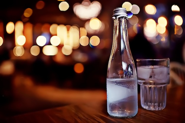 lemonade in glass cafe / fresh lemonade with ice and lime in a glass on a restaurant background