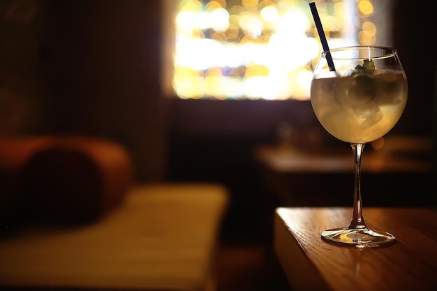 lemonade in glass cafe / fresh lemonade with ice and lime in a glass on a restaurant background