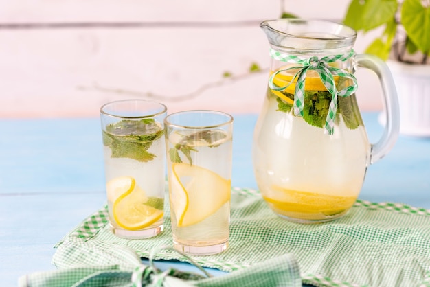 Lemonade made at home on a white wooden surface