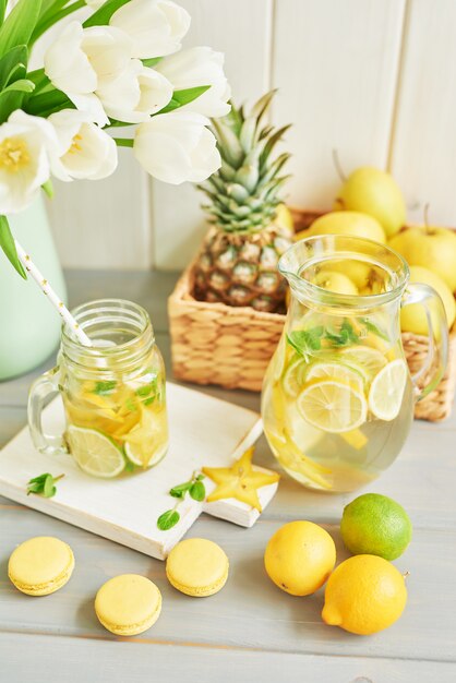 Lemonade, sweet macarons and tulip flowers