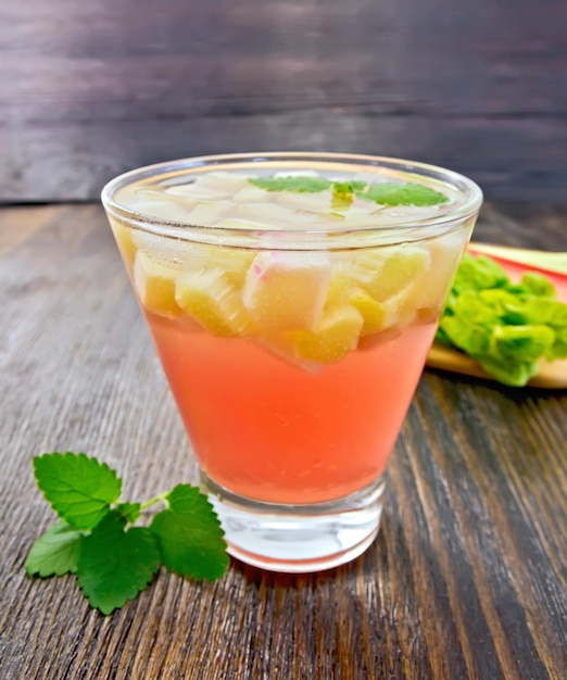 Lemonade with rhubarb and mint on dark board