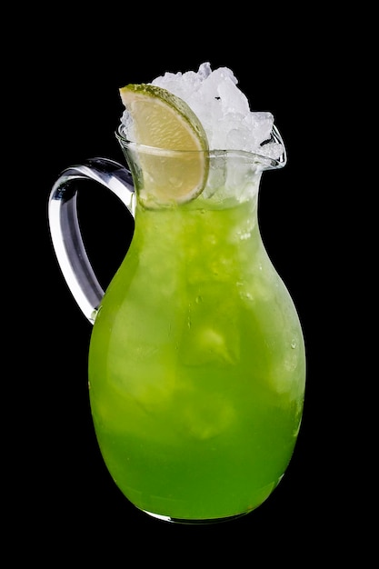 Lemonade with tarragon in a glass jug on a dark background