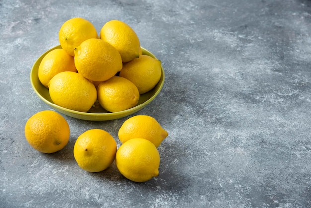 Lemons in bowl on grey backround