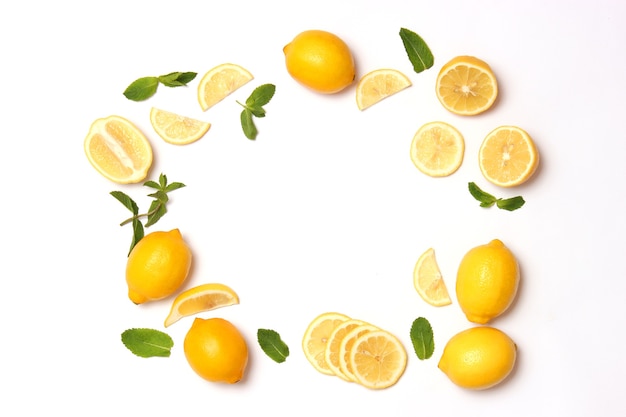 Lemons and green leaves on a colored background