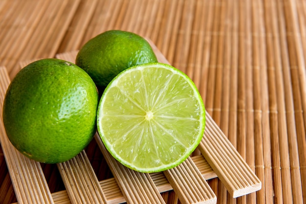 Lemons and half a lemon on a wooden table.