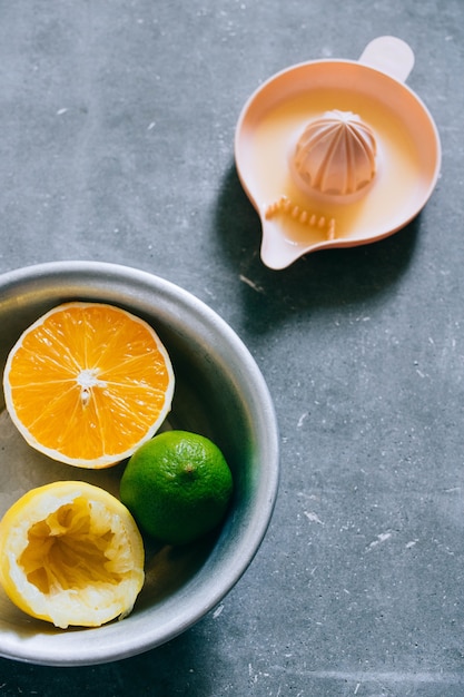 Lemons, lime, orange in a metal plate