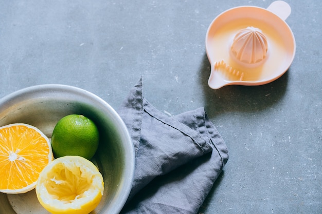 Lemons, lime, orange in a metal plate