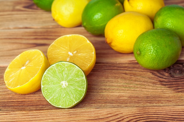 lemons and limes on wooden pad