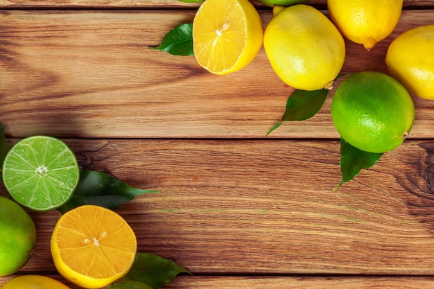 Lemons and limes on wooden pad