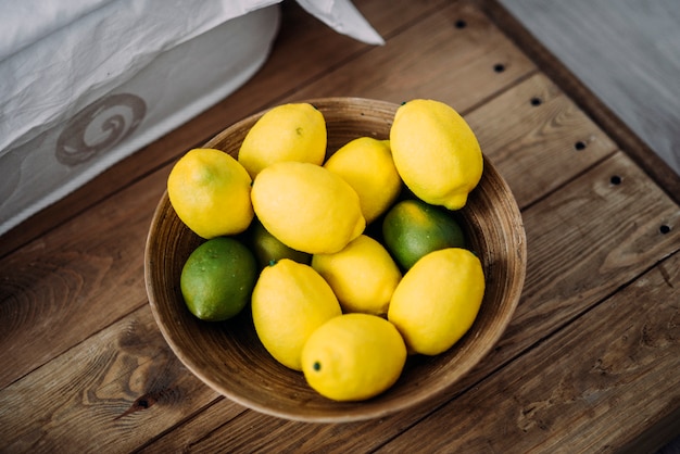 Lemons and limes on the wooden table