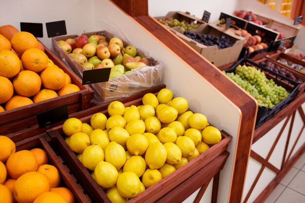 Lemons and other fruits in a box on the counter of a vegetable store