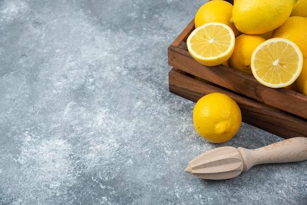 Lemons in wood box sliced and full freshly composition grey backround